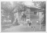 Rosie with doll at Alaskan cabin